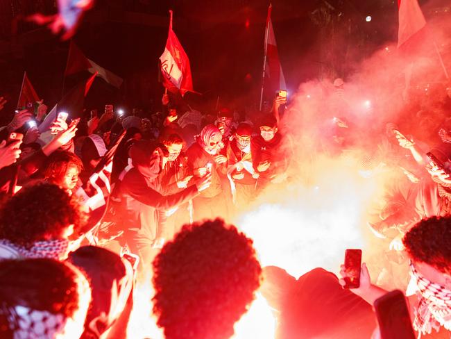 Flares were lit at Monday’s rally and an Israeli flag was set alight. Picture: David Swift