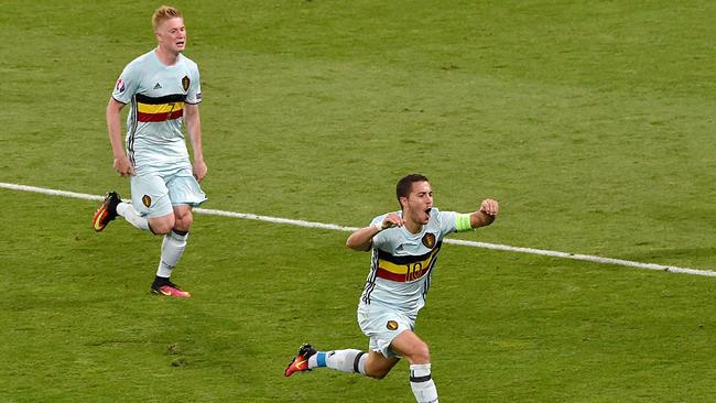 Belgium's forward Eden Hazard (R) celebrates scoring his team's third goal.