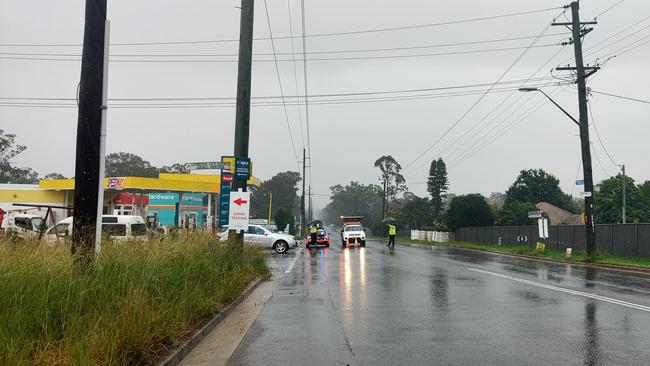 Police and SES stop residents from driving up Fifteenth Ave in Austral, as it's completely flooded. Picture: Paul Brescia