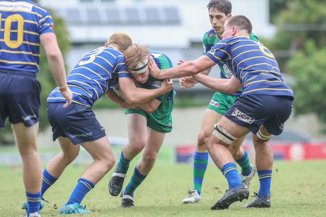 Tom MIllard is tackled by Larry Clark in round 9 between Easts and GPS.