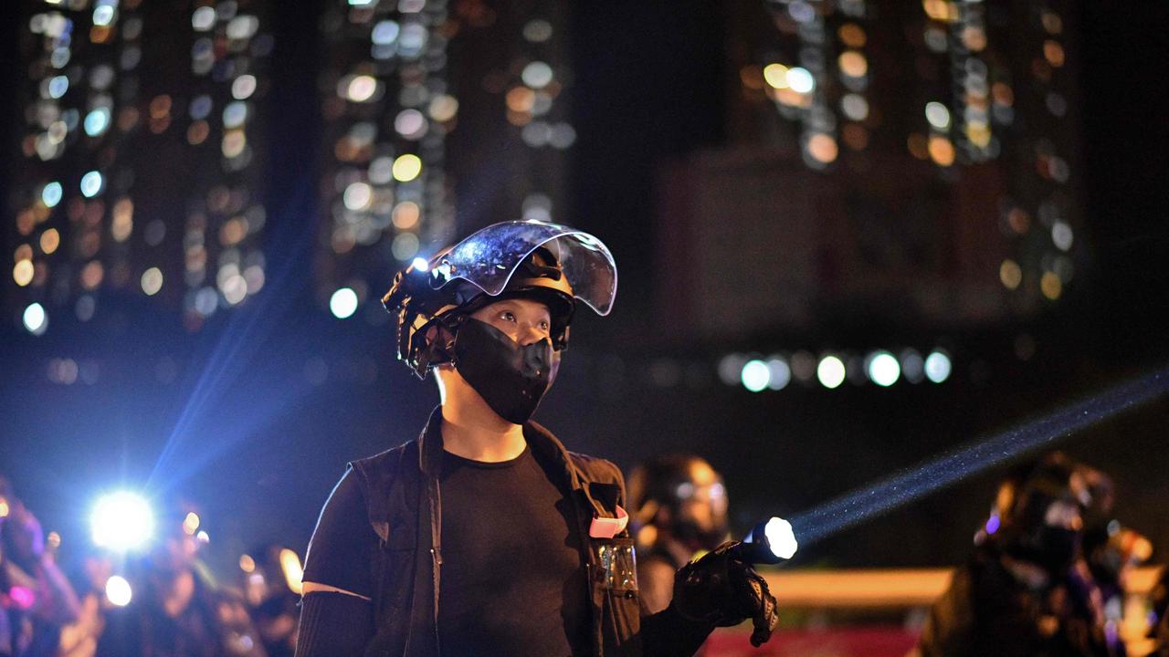 Riot police shone lights on protesters as demonstrations were held in support of activist Edward Leung on Wednesday.