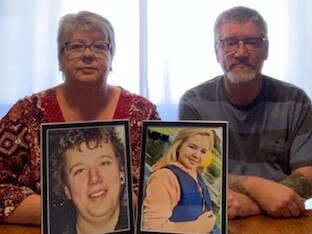 Lynette and Leigh Lyall with photos of their children, Troy and Shanae.