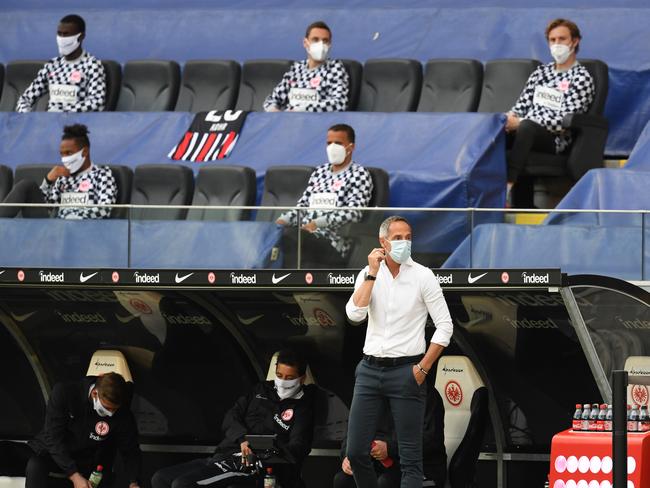 FRANKFURT AM MAIN, GERMANY - MAY 26: Head Coach Adi Hutter looks on from the bench while wearing a face mask during the Bundesliga match between Eintracht Frankfurt and Sport-Club Freiburg at Commerzbank-Arena on May 26, 2020 in Frankfurt am Main, Germany. (Photo by Arne Dedert/Pool via Getty Images)