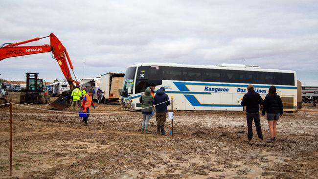 A bus stuck in mud as it arrives at the Big Red Bash site. Picture: Danica Clayton