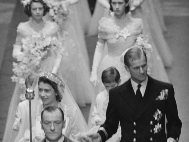 Princess Elizabeth and Prince Philip make their way down the aisle of Westminster Abbey, London, on their wedding day. Picture: Getty