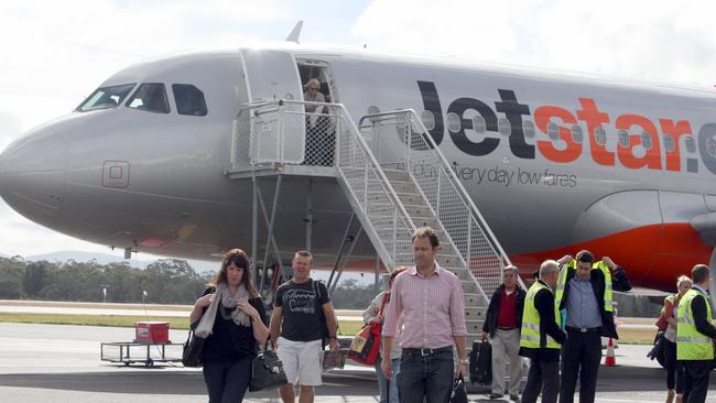 Passengers disembark from a Jetstar flight at Hobart Airport.