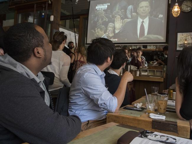 Brooklynites watch on as former FBI director James Comey testifies during a Senate Intelligence Committee hearing. Picture: AP/Mary Altaffer