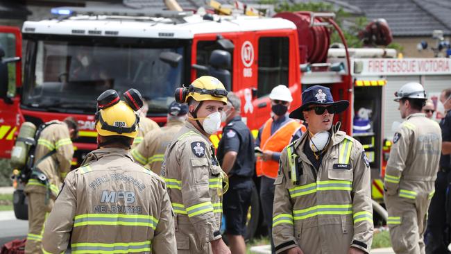 Police and fire fighters at the scene of the apartment fire in Point Cook that claimed three lives. Picture: David Crosling