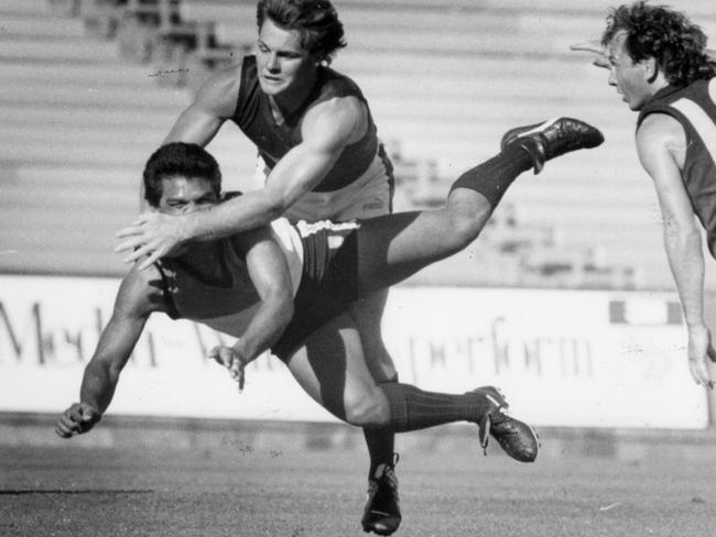 Cyril Rioli Jr playing for the NT being hit in the nose by a Tasmanian opponent at the Bicentennial Carnival match at Football Park in 1988.