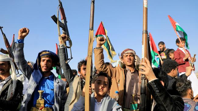 Yemeni protesters brandish weapons during a protest in the Huthi-controlled capital Sanaa following US and British forces strikes. Picture: AFP