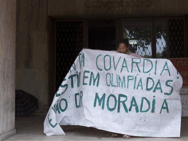 A woman protests inside the abandoned building.