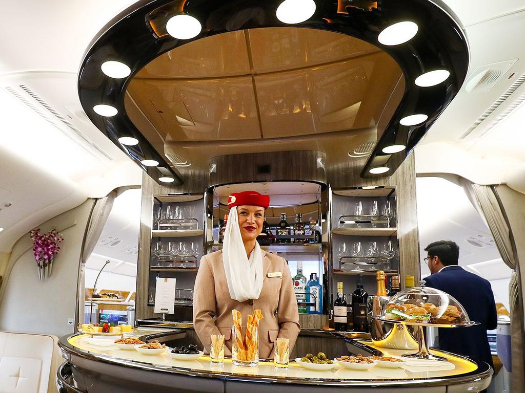 An Emirates flight attendant in first class.