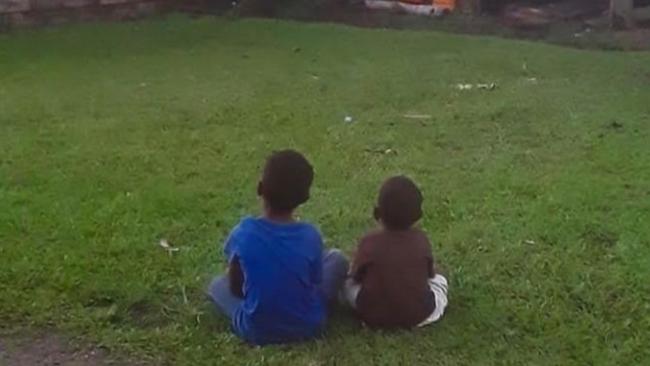 Two young boys watch the game. Picture: Teivovo Rugby