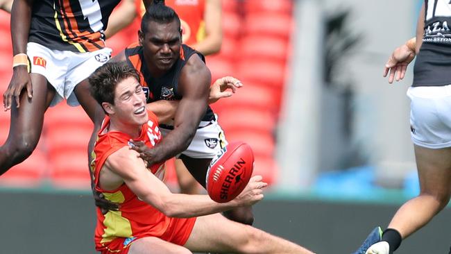 Gold Coast Bulletin only Please check with Picture Editor before use. Gold Coast Suns NEAFL elimination final against Northern Territory Thunder at Metricon Stadium. Photo of Daniel Charlesworth tackled. Photo by Richard Gosling