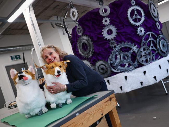 Jane Hytch, Chief Executive of Imagineer, hugs a life-size model of a corgi dog beside a giant model of a crown in the company's workshop in Coventry. Picture: AFP