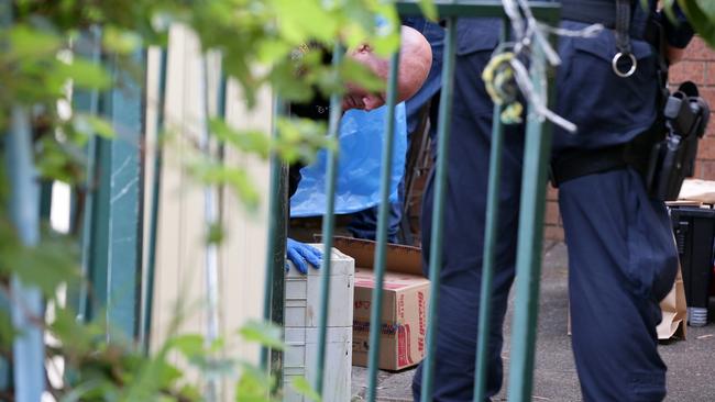 Police go through property at an Auburn address. Picture: Jonathan Ng