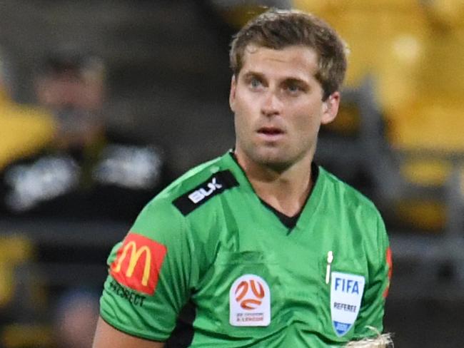 Ola Toivonen of the Melbourne Victory kneels down in front of referee Alex King as he awaits a VAR descision on a goal against the Phoenix during the Round 23 A-League match between Wellington Phoenix and Melbourne Victory at Westpac Stadium in Wellington, Sunday, March 15, 2020. (AAP Image/Ross Setford) NO ARCHIVING, EDITORIAL USE ONLY