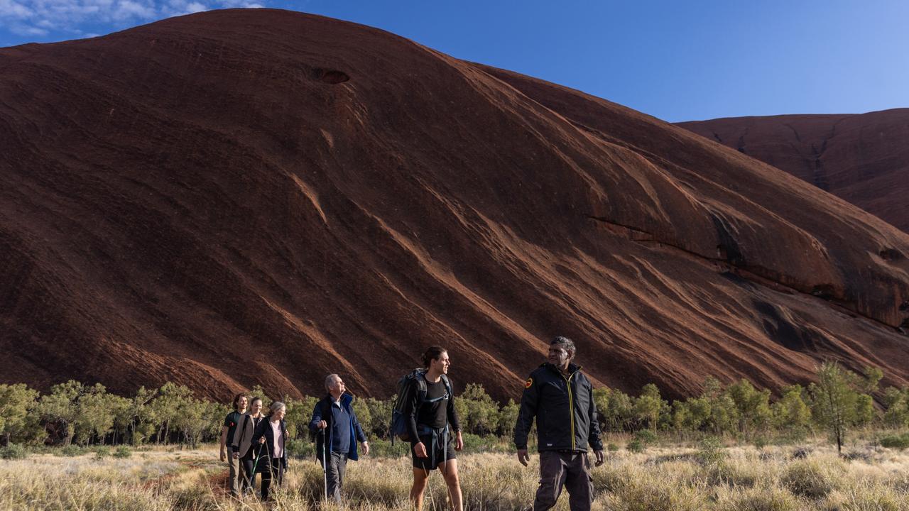 Walkers at the base of Uluru. Picture: Helen Orr.