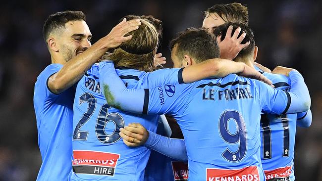 Milos Ninkovic is congratulated by teammates after scoring a goal during the round 22 A-League match between the Melbourne Victory and Sydney FC.