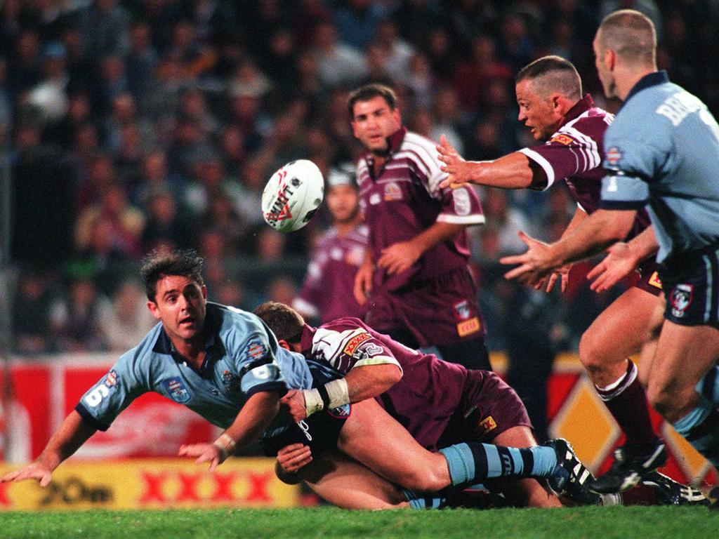 Brad Fittler (L) gets a pass away to Tim Brasher (R) during game three of the 1996 series.