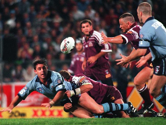 Brad Fittler (L) gets a pass away to Tim Brasher (R) during game three of the 1996 series.