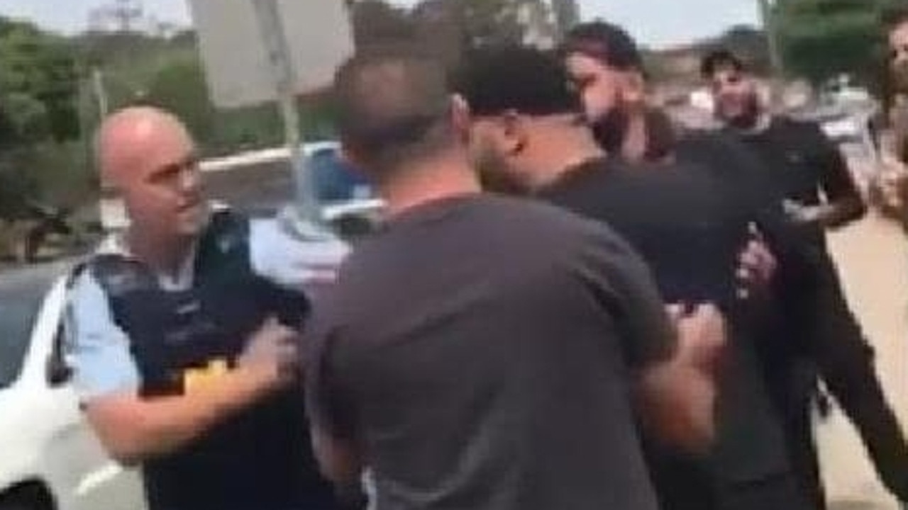 He clashes with mourners heading to the funeral of slain bikie boss Mick Hawi.