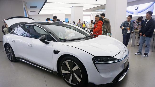 Visitors look at the Luxeed S7, the first sedan produced by Chinese tech giant Huawei, at a Huawei showroom in Hangzhou, in Chinaâs eastern Zhejiang province on December 12, 2023. (Photo by AFP) / China OUT