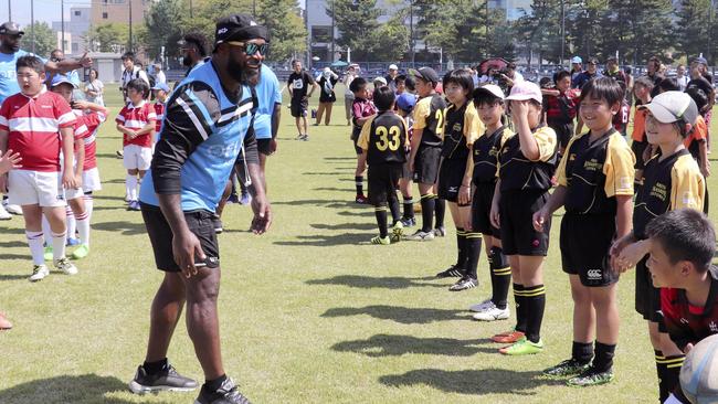 The Fijians give a rugby clinic to some Japanese children.