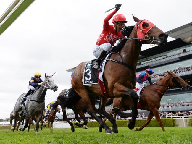 Jockey Kerrin McEvoy on Redzel raises his arm at the finish line as they win The TAB Everest race last year. Picture: AAP Image/David Moir