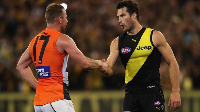 Steve Johnson and Alex Rance shake hands at the end of the game. Picture: Phil Hillyard