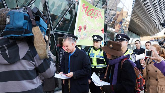 Protesters greet Premier Jay Weatherill as he arrives for a meeting of the nuclear waste citizens’ jury at the SAHMRI building.