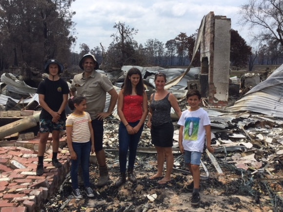 The Zagami family survey the damage on their Wairewa farm after the Black Summer bushfires.