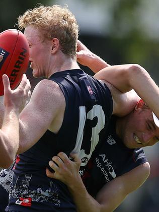 Bernie Vince lays a strong tackle on Clayton Oliver. Picture: Wayne Ludbey