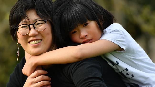 Artist Jung Yoon and her 10-year-old daughter Joanne who has autism pose for a photograph in Adelaide on Thursday the 19th of September 2019. Jung has come up with a project titled "Let's Be Friends", which includes a book, classroom learning resources and a documentary.  (AAP Image/Keryn Stevens)