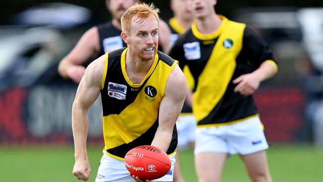 James Gaff of Kyneton handballs during the round two RDFNL Bendigo Bank Seniors match between Riddell and Kyneton at Riddells Creek Recreation Reserve, on April 13,2024, in Diggers Rest, Australia. (Photo by Josh Chadwick)