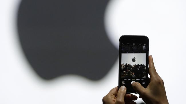 A person takes a photo of an Apple logo before the last announcement of new products at the Apple Worldwide Developers Conference in June. Picture: AP