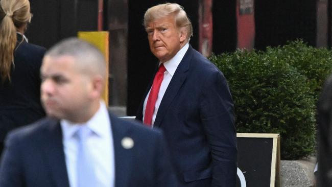 Former US President Donald Trump arrives at Trump Tower ahead of his surrender tomorrow. Picture: AFP.