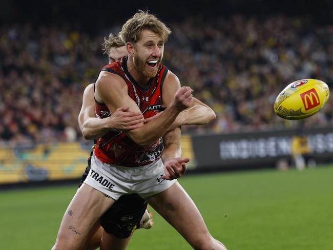 Dyson Heppell gets away a handball for the Bombers in Dreamtime at the ’G. Picture: Michael Klein