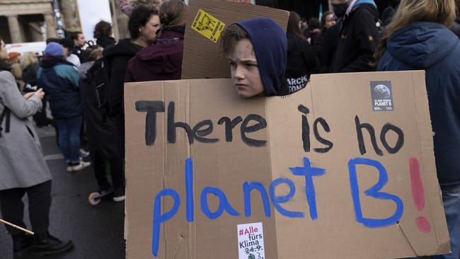 A child holds a sign as people gather for a demonstration in Berlin.