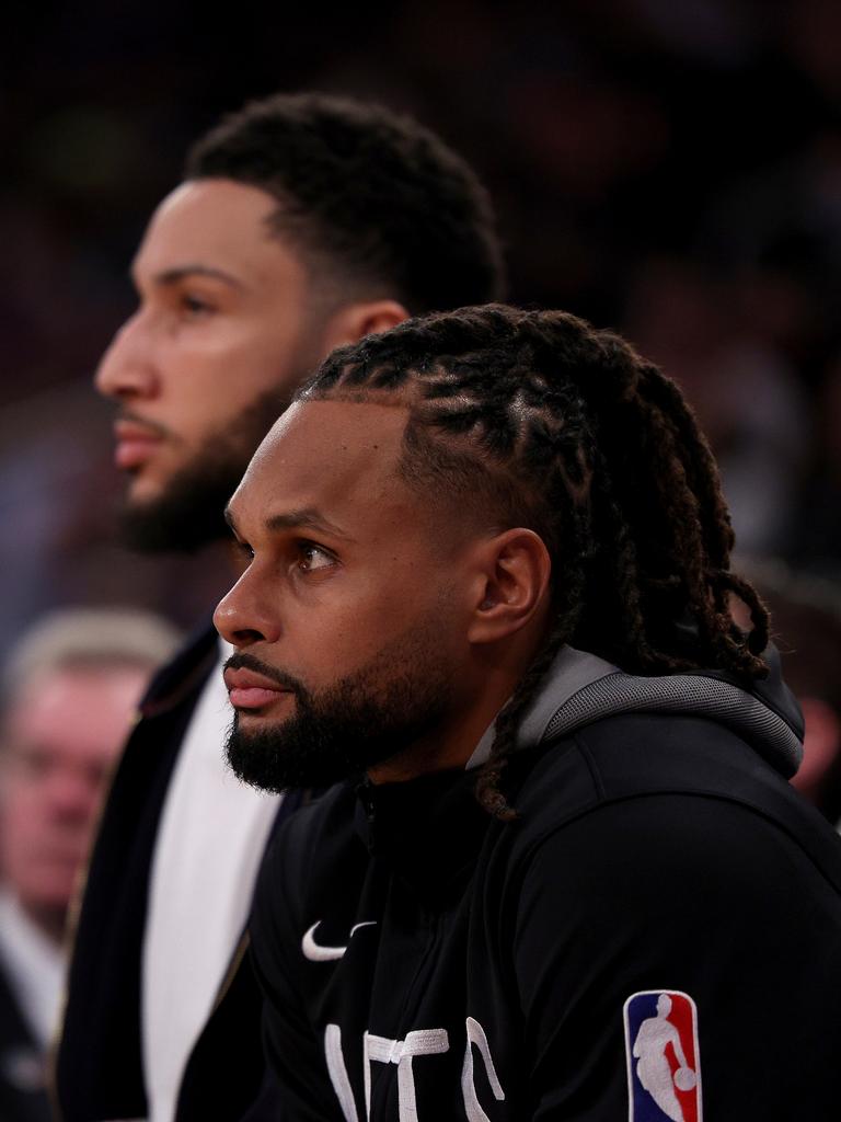 Simmons on the sidelines with Patty Mills. (Photo by Elsa/Getty Images)