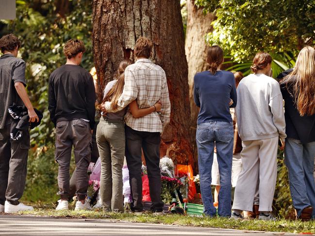 Friends of the deceased gather on Saturday at the tree the ute crash into around lunchtime. Picture: Sam Ruttyn