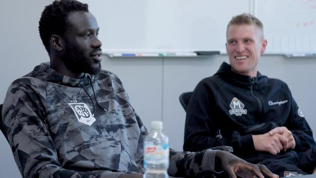 Jo Lual-Acuil meets with Melbourne United assistant coach Rhys Carter and staff on his return to the club. Picture: Behind the Blue/Melbourne United