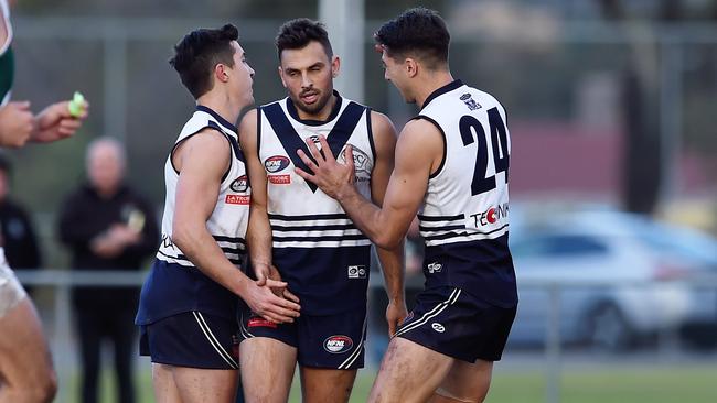 Sam Lloyd is congratulated by teammates after a goal. Picture: Steve Tanner