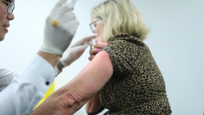 Lyn Robertson gets a vaccination jab from Dr Lawrence Chan at the Northbridge Medical Centre. Picture: NCA NewsWire/CHRISTIAN GILLES