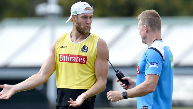 Ben Reid chats to coach Nathan Buckley at training. He will play as a permanent forward in 2018. Picture: Nicole Garmston