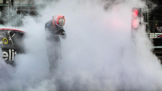 Nick Percat climbs out from his car after it caught fire during race 2. Picture: Daniel Kalisz/Getty Images)