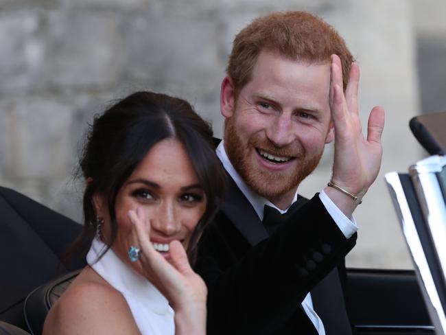 WINDSOR, UNITED KINGDOM - MAY 19: Prince Harry, Duke of Sussex and Meghan, Duchess of Sussex wave as they leave Windsor Castle after their wedding to attend an evening reception at Frogmore House, hosted by the Prince of Wales on May 19, 2018 in Windsor, England. (Photo by Steve Parsons - WPA Pool/Getty Images)