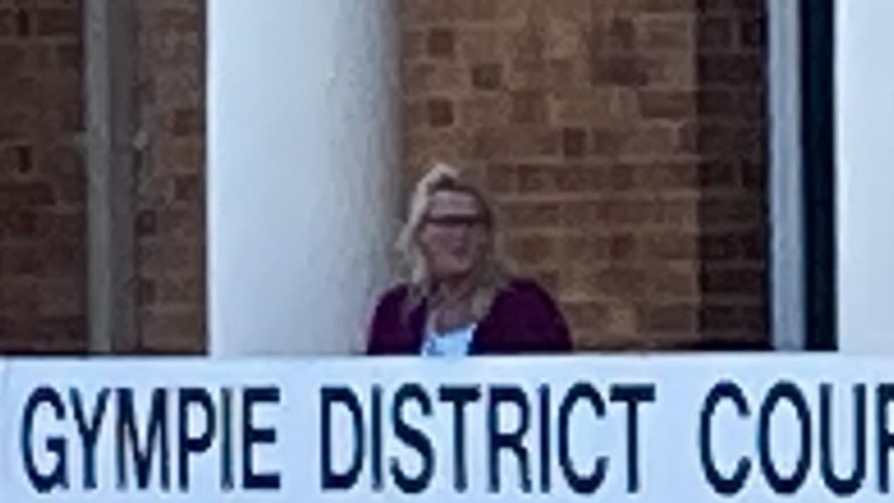 Kay Lorraine Menzies (maroon jumper) leaves Gympie District Court surrounded by family and friends.