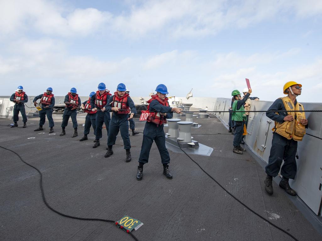 210715-N-XB010-1006 CORAL SEA (July 15, 2021) Sailors assigned to USS New Orleans (LPD 18) handle line during a replenishment at sea with USNS Rappahannock (T-AO-204) . New Orleans, part of the America Expeditionary Strike Group, along with the 31st MEU, is operating in the U.S. 7th Fleet area of responsibility to enhance interoperability with allies and partners and serve as a ready response force to defend peace and stability in the Indo-Pacific region. (U.S. Navy photo by Mass Communication Specialist 2nd Class Desmond Parks)