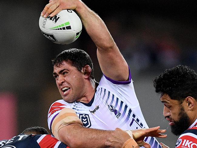 Dale Finucane of the Storm is tackled by Sio Siua Taukeiaho (left) and Isaac Liu of the Roosters during the NRL Preliminary Final match between the Sydney Roosters and Melbourne Storm at the SCG in Sydney, Saturday, September 28, 2019. (AAP Image/Dan Himbrechts) NO ARCHIVING, EDITORIAL USE ONLY